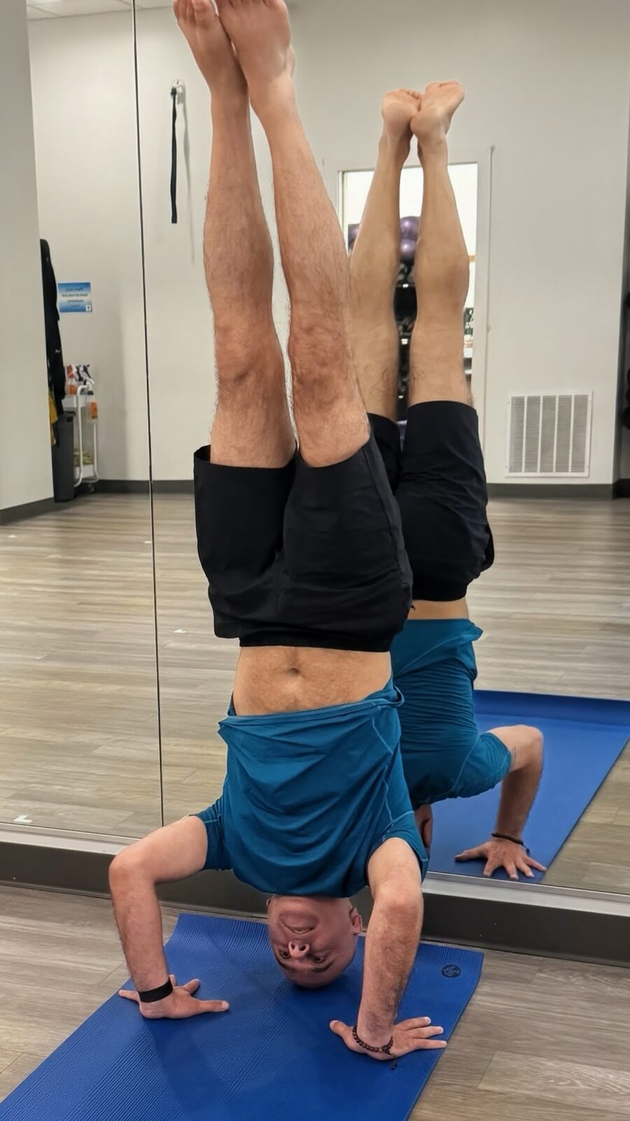 Raj in tripod headstand with legs straight up